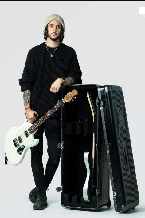 Bad/Love a guitar next to an open triple guitar case on a white background