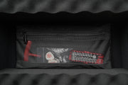 Black pouch with mesh pocket on a dark textured background