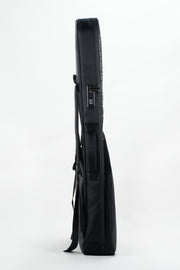 A black hard-shell guitar gig bag shown in profile against a clean white studio background.